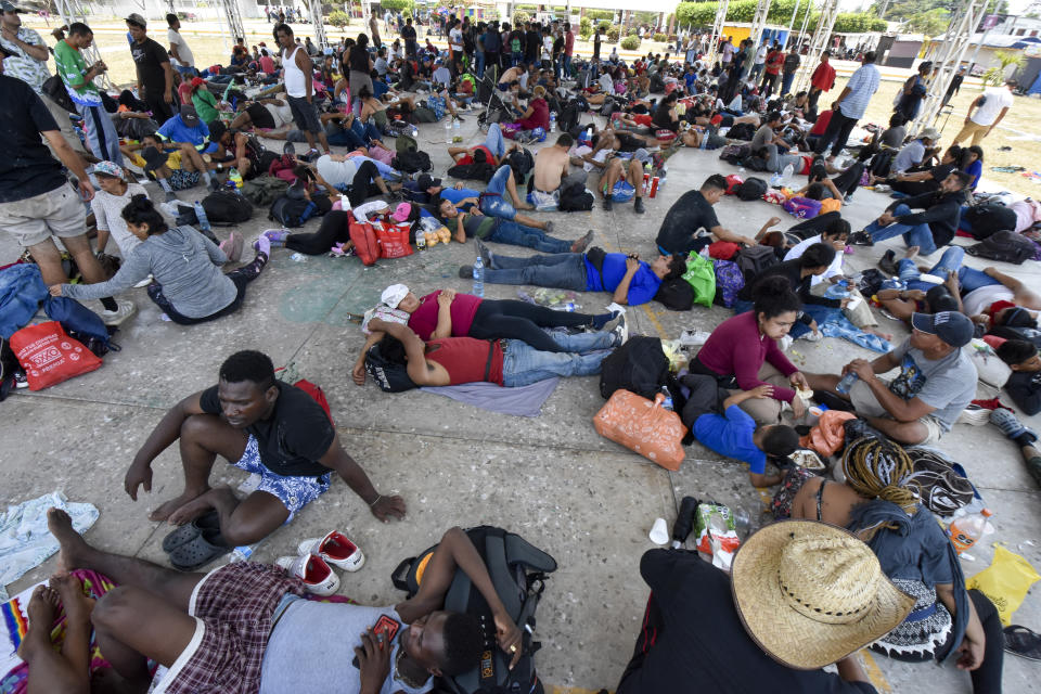 Migrants who are taking part in a caravan rest on the outskirts of Tapachula, Chiapas state, Mexico, Sunday, April 23, 2023. Migrants set out Sunday on what they call a mass protest procession through southern Mexico to demand the end of detention centers like the one that caught fire last month, killing 40 migrants. (AP Photo/Edgar H. Clemente)