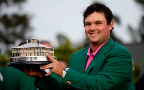 Patrick Reed holds the championship trophy after winning the Masters golf tournament Sunday, April 8, 2018, in Augusta, Ga. - Credit: AP