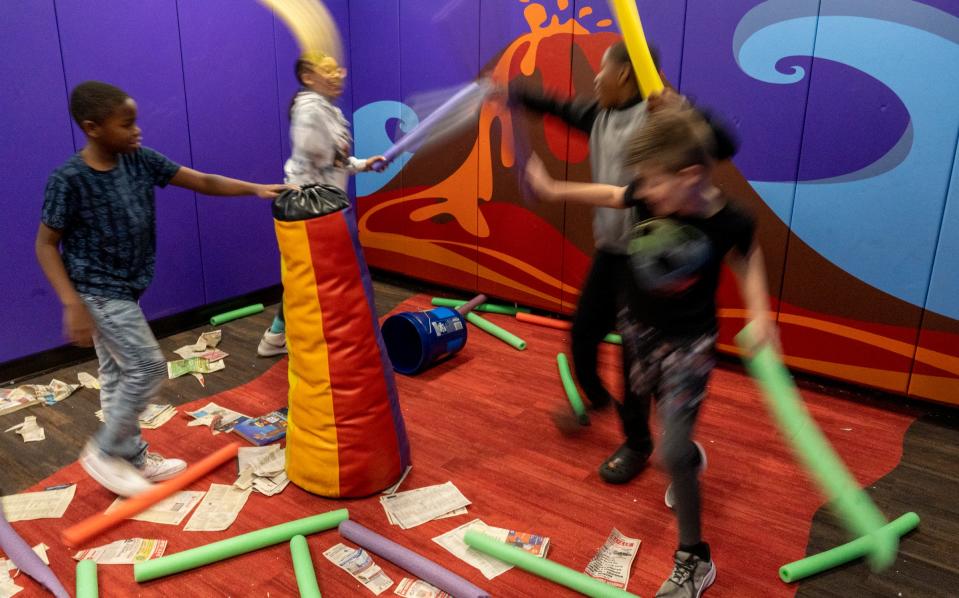 Kids blow off some steam and have fun beating things with pool noodles on Monday, Dec. 12, 2022, at a meeting for Brooke’s Place, which helps grieving young people. 