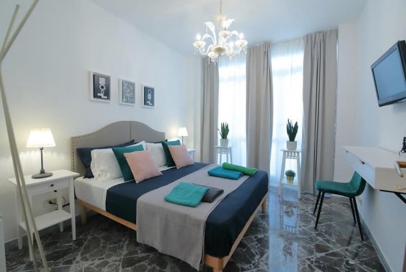 Hotel room with tall windows and little chandelier