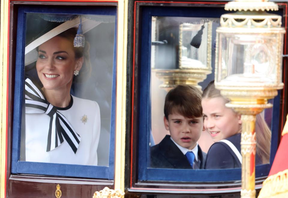 Kate, Prince Louis and Princess Charlotte smile out to crowds on The Mall (Getty Images)