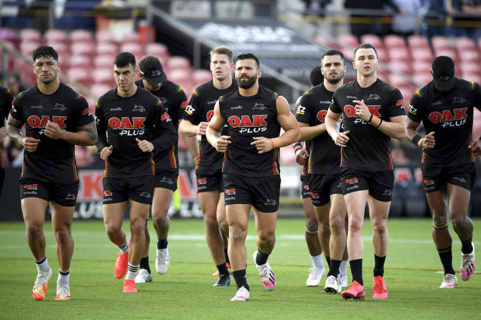 Josh Mansour of the Panthers, center, and teammates take to the field during an open training session and fan day at Panthers Stadium, Sydney, Tuesday, Oct. 20, 2020. The Penrith Panthers will take on The Melbourne Storm in the 2020 NRL Grand Final this Sunday. The final will be played in its regular Olympic stadium location in Sydney, only about 40,000 spectators will be allowed in the 85,000-seat venue because of social distancing regulations and crowd restrictions.(Dan Himbrechts/AAP Image via AP)