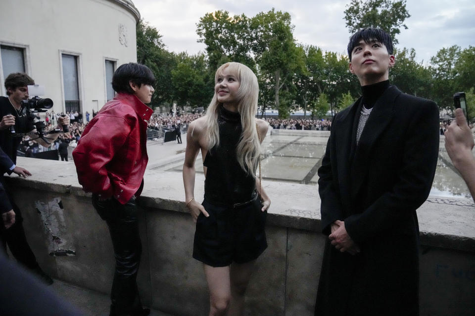 V, from left, Lisa, and Park Bo-gum pose for photographers before the Celine men's Spring Summer 2023 collection presented in Paris, France, Sunday, June 26, 2022. (AP Photo/Francois Mori)