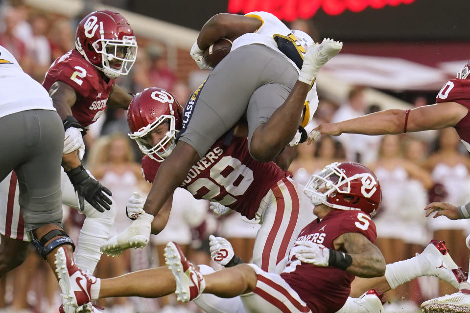 Oklahoma linebacker Danny Stutsman (28) tackles Kent State running back Bryan Bradford, top, in the first half of an NCAA college football game, Saturday, Sept. 10, 2022, in Norman, Okla. (AP Photo/Sue Ogrocki)