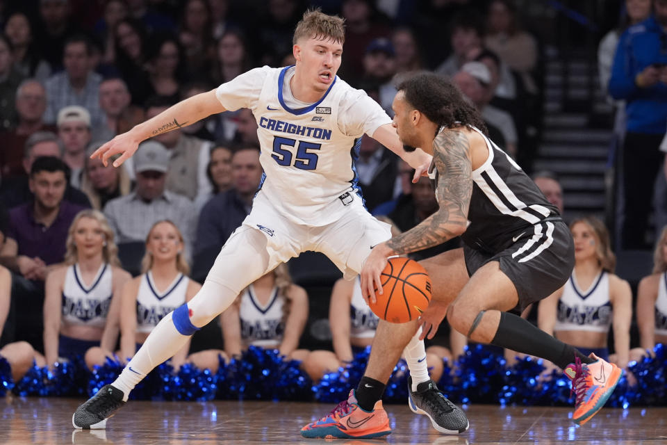 Creighton guard Baylor Scheierman (55) defends against Providence guard Devin Carter during the first half of an NCAA college basketball game in the quarterfinals of the Big East Conference tournament Thursday, March 14, 2024, in New York. (AP Photo/Mary Altaffer)