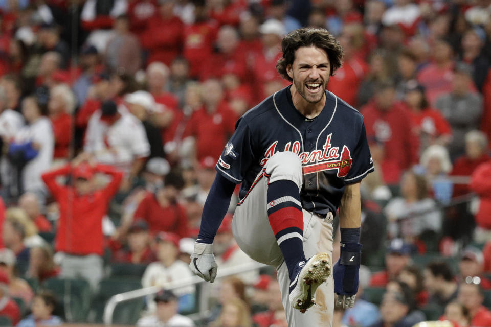 Atlanta Braves' Dansby Swanson celebrates after scoring during the ninth inning in Game 3 of a National League Division Series against the St. Louis Cardinals, Sunday, Oct. 6, 2019, in St. Louis. (AP Photo/Charlie Riedel)