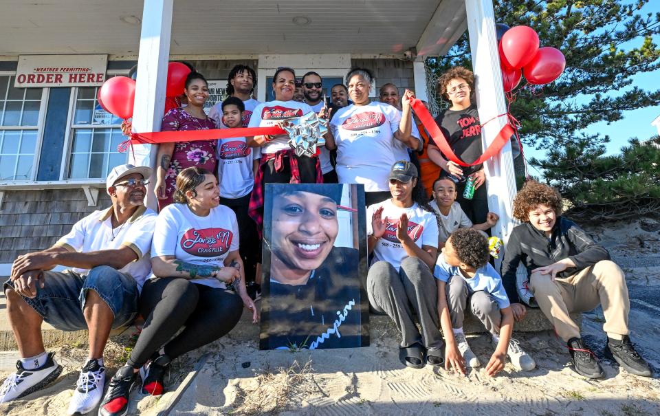 Jeneen Texeira, left, and Paulene Jones cut an opening ribbon on Monday at Jones' N at Craigville with a memorial for Paulene's daughter, Junelle Jones Saunders, who died a year ago on April 15. Community members were invited although the actual opening is scheduled for Memorial Day.