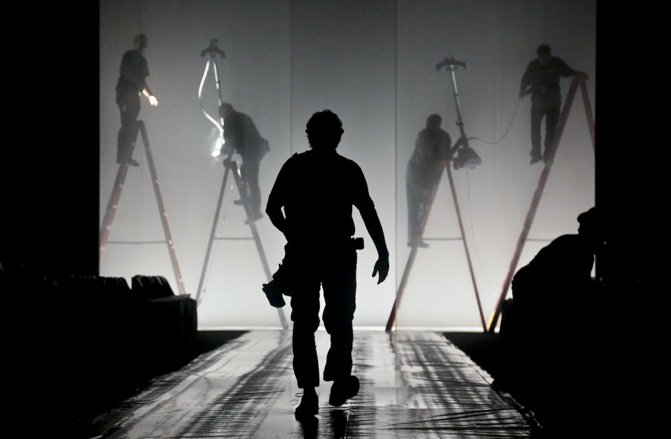 Production crew work on final details on the runway set for the showing of the J. Mendel Spring 2014 collection on Wednesday, Sept. 11, 2013 in New York. (AP Photo/Bebeto Matthews)