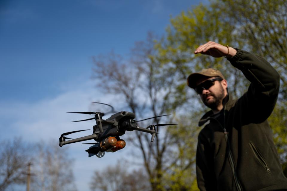 A Ukrainian soldier loads dummy grenades on a drone for target practice in the region of Dnipro, Ukraine, on April 18, 2023.