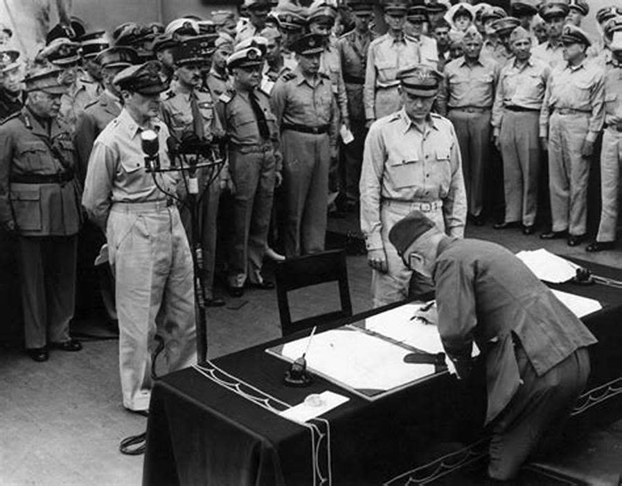 The Foreign Minister of Japan signs the documents to end the war.