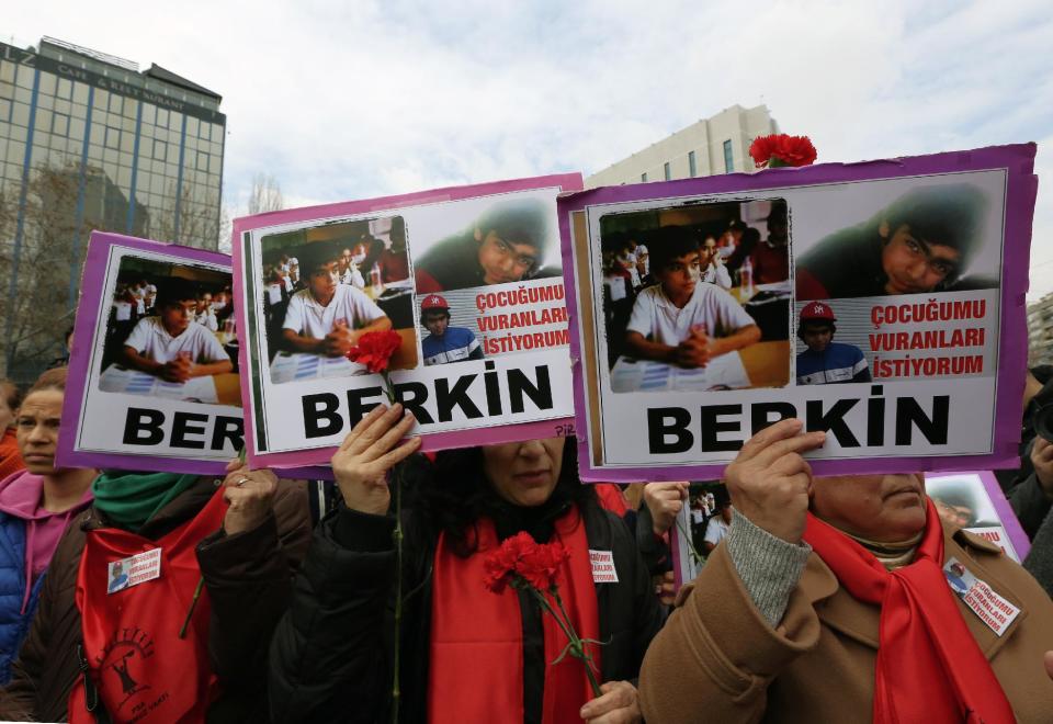 The women hold posters of Berkin Elvan, a Turkish teenager who has died but was was in a coma after being hit on the head by a tear gas canister fired by police during last summer's anti-government protests, during a protest in Ankara, Turkey, Wednesday, March 12, 2014. On Wednesday, thousands converged in front of a house of worship in Istanbul calling for Prime Minister Recep Tayyip Erdogan to resign. The placards read: " I want the killers of my child."(AP Photo/Burhan Ozbilici)