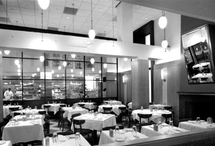 <p>Open kitchens might be pretty common in restaurants today, but in the '90s they were almost always tucked away. That wasn't the case at the then-new Bistro Bis at the George Hotel (now the Kimpton George Hotel), where diners could peer into the kitchen from their tables.</p>