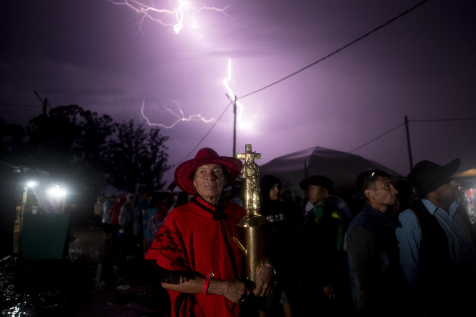 Julio Rivero holds a figure of Argentina's folk Saint "Gauchito" Gil at his sanctuary in Mercedes, Corrientes, Argentina, Sunday, Jan. 7, 2024. Every Jan. 8, devotees from across the country visit his sanctuary to ask for miracles or give him thanks. (AP Photo/Mario De Fina)