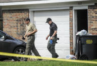 A Morgan County, Ala. investigators work at the scene, Friday, June 5, 2020, in Valhermoso Springs, Ala., where numerous people were found fatally shot. Deputies responding to a call about a shooting in Alabama found seven people dead inside a home that had been set afire early Friday, authorities said. (Jeronimo Nisa/The Decatur Daily via AP)