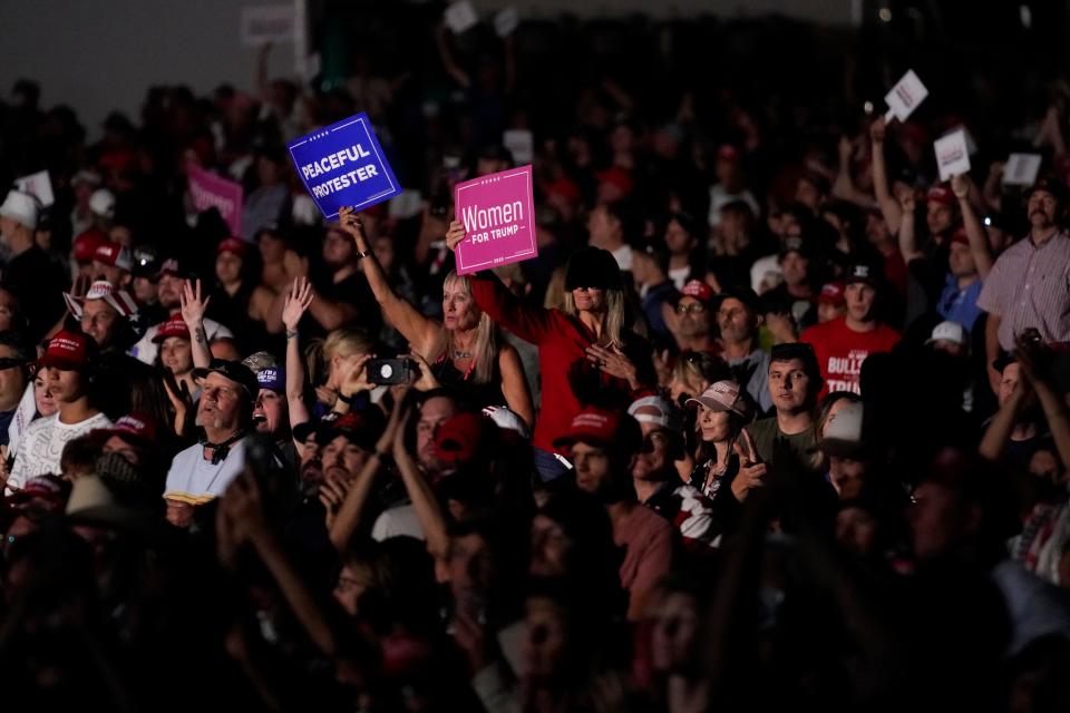 Supporters listen as President Donald Trump speaks at a rally Saturday night at Minden-Tahoe Airport in Minden, Nevada. The rally was Trump's opening event on a three-day campaign swing through the West.