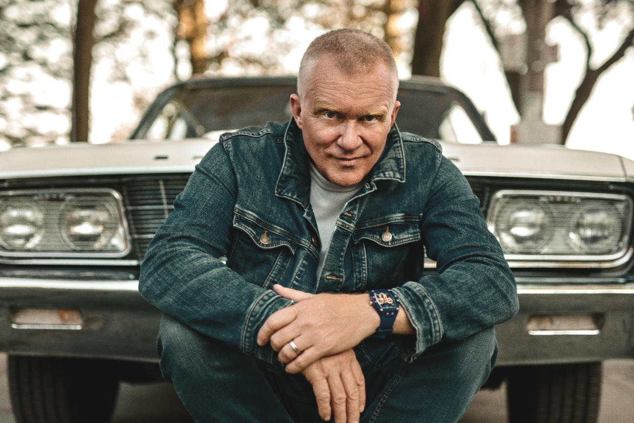 The actor Anthony Michael Hall in front of a car in a scene from the movie.