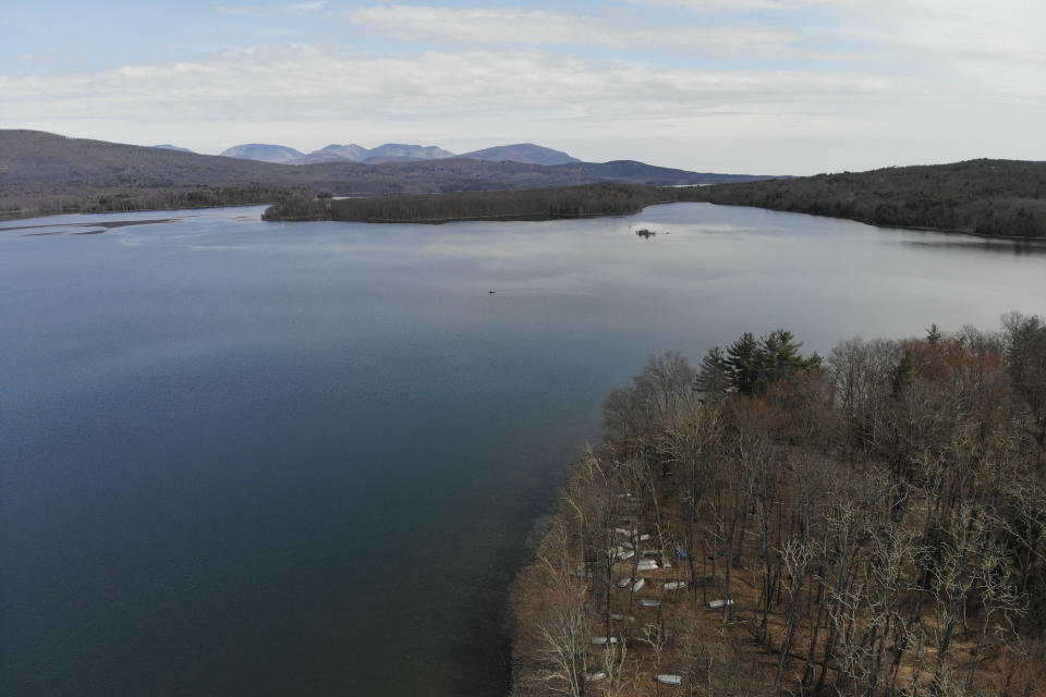 A motorized boat makes its way on the Ashokan Reservoir in Olive, N.Y., Tuesday, April 5, 2022. As western regions contend with drier conditions, New York City is under fire for sometimes releasing hundreds of millions of gallons of water a day from the reservoir in the Catskill Mountains. The occasional releases, often around storms, have been used to manage water the reservoir's levels and to keep the water clear. But residents downstream say the periodic surges cause ecological harm along the lower Esopus Creek. (AP Photo/Seth Wenig)