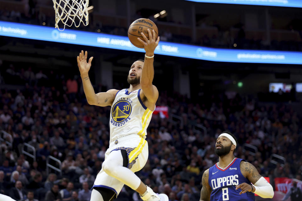 Golden State Warriors guard Stephen Curry (30) shoots against Los Angeles Clippers forward Marcus Morris Sr. (8) during the first half of an NBA basketball game in San Francisco, Tuesday, March 8, 2022. (AP Photo/Jed Jacobsohn)