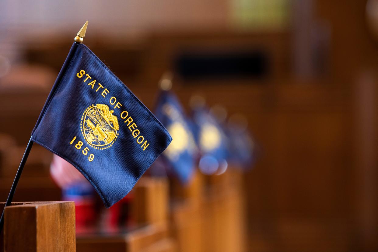 Miniature State of Oregon flags are displayed in the Senate floor in the Capitol in Salem, Ore. on Tuesday, Feb. 9, 2021.