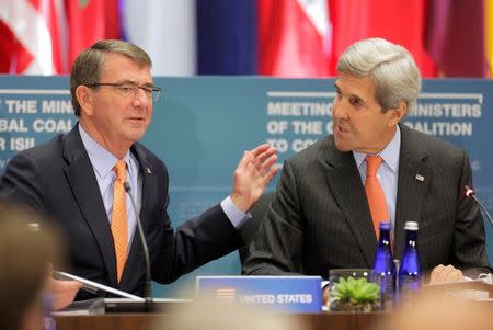 U.S. Secretary of State John Kerry (R) and U.S. Secretary of Defense Ash Carter speak at a "Meeting of the Ministers of the Global Coalition to Counter ISIL: Joint Plenary Session" at the State Department in Washington, U.S., July 21, 2016. REUTERS/Joshua Roberts