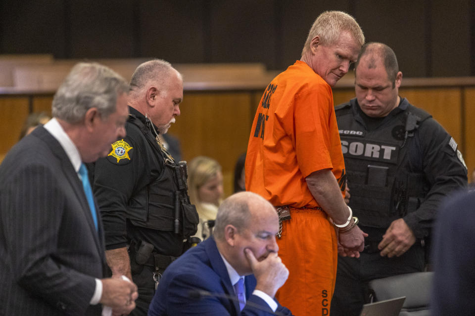 Alex Murdaugh, second from right, has his handcuffs removed during a jury-tampering hearing at the Richland County Judicial Center, Monday, Jan. 29, 2024, in Columbia, S.C. (Andrew J. Whitaker/The Post And Courier via AP, Pool)