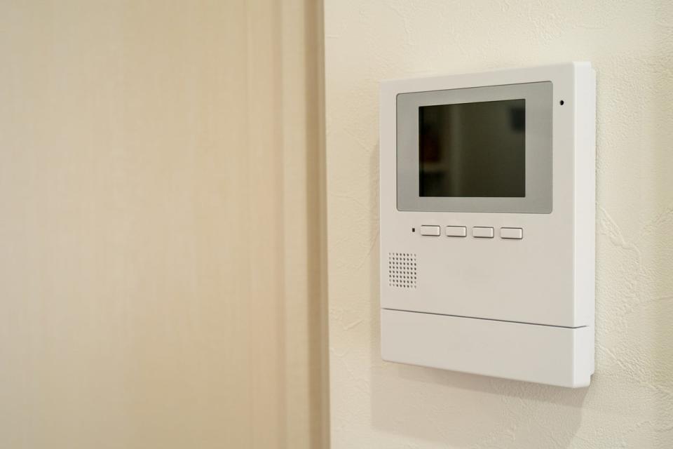 A close up of a wall-mounted home automation panel.