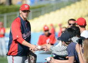 LOS ANGELES, CA - APRIL 28: Bryce Harper #34 of the Washington Nationals sings autographs as he makes his major league debut during practice before the game against the Los Angeles Dodgers at Dodger Stadium on April 28, 2012 in Los Angeles, California. (Photo by Harry How/Getty Images)
