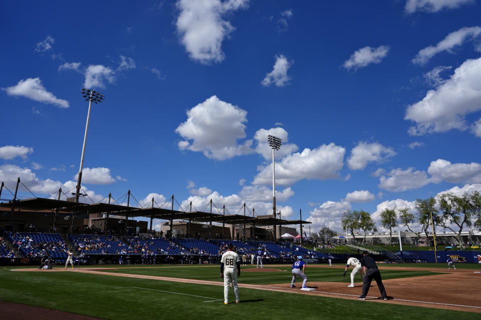 The Texas Rangers and the Milwaukee Brewers compete during the second inning of a spring training baseball game, Saturday, March 16, 2024, in Phoenix. (AP Photo/Matt York)