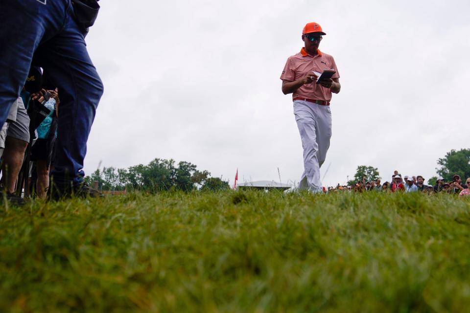 Rickie Fowler makes his way to the his ball in the out of bounds section during the playoffs of the Rocket Mortgage Classic at Detroit Golf Club on Sunday, July 2, 2023.