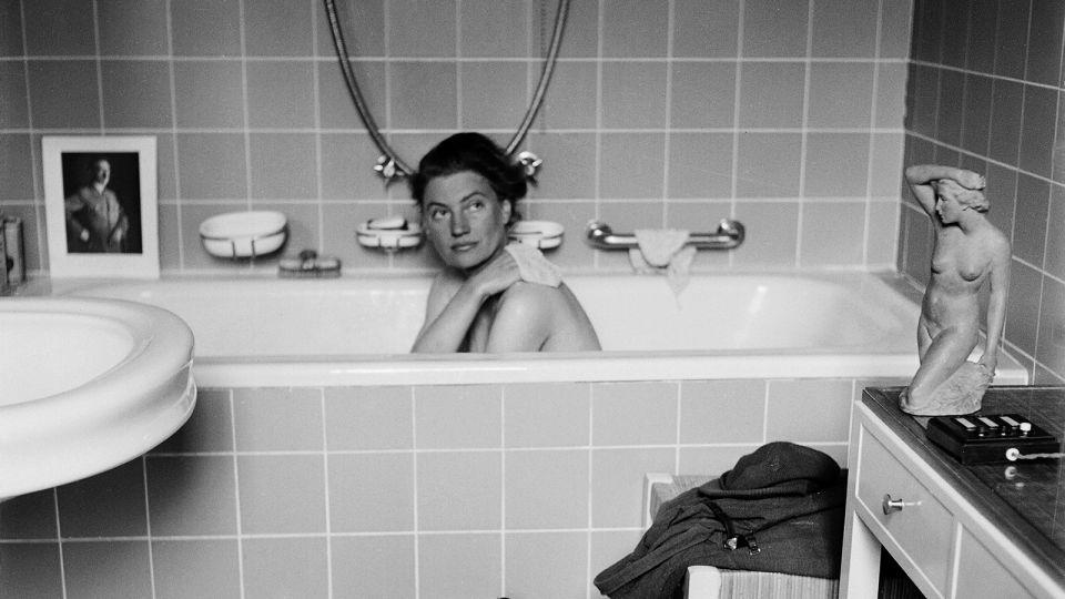 This portrait of Miller in Hitler's bathtub in Munich on the day of his death — her boots dirtying his bathmat — has become one of the images for which she is most known. - Lee Miller Archives, England 2023
