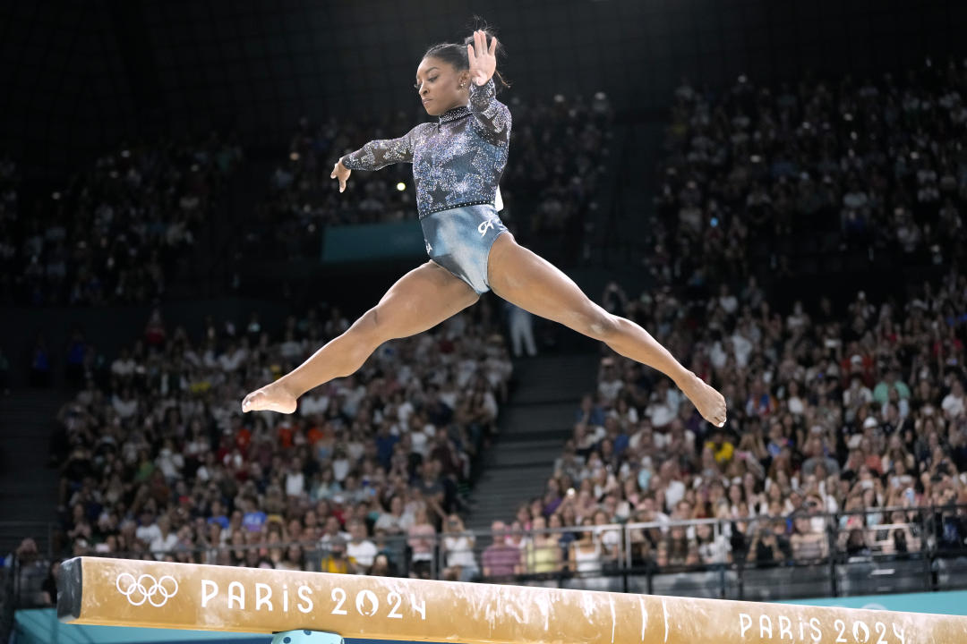 Simone Biles of the United States competes on the balance beam during a women's artistic gymnastics qualification round at the 2024 Summer Olympics, Sunday, July 28, 2024, in Paris, France. (AP Photo/Charlie Riedel)