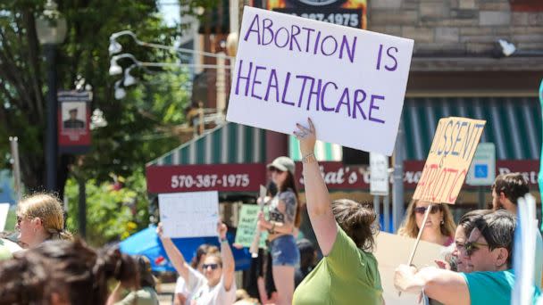 PHOTO: A woman holds a placard saying 'abortion is healthcare' during an abortion rights rally organized in response to the US Supreme Court's decision to overturn Roe v. Wade, in Bloomsburg, Pa., July 3, 2022. (SOPA Images/LightRocket via Getty Images, FILE)