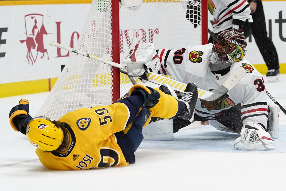 Nashville Predators defenseman Roman Josi (59) falls after scoring the winning goal against Chicago Blackhawks goaltender Malcolm Subban (30) in overtime of an NHL hockey game Tuesday, Jan. 26, 2021, in Nashville, Tenn. The Predators won 3-2. (AP Photo/Mark Humphrey)