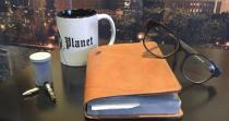 <p>No good reporter would be without notebook, glasses, and coffee mug.</p>