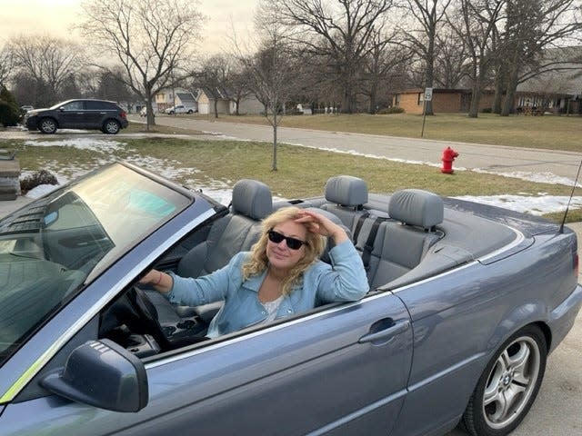 Phoebe Wall Howard, seen here in her 2004 BMW on Wednesday, February 8, 2023, can't believe she purchased her first convertible. Now she just needs to do a little repair work.
