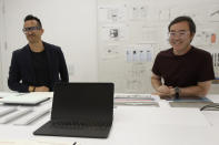 In this Tuesday, Sept. 24, 2019, photo a new Pixel laptop computer is shown in front of Alberto Villarreal, Creative Lead for Mobile and Laptops, left, and Max Yoshimoto, Design Director of Mobile and Create, at Google in Mountain View, Calif. (AP Photo/Jeff Chiu)