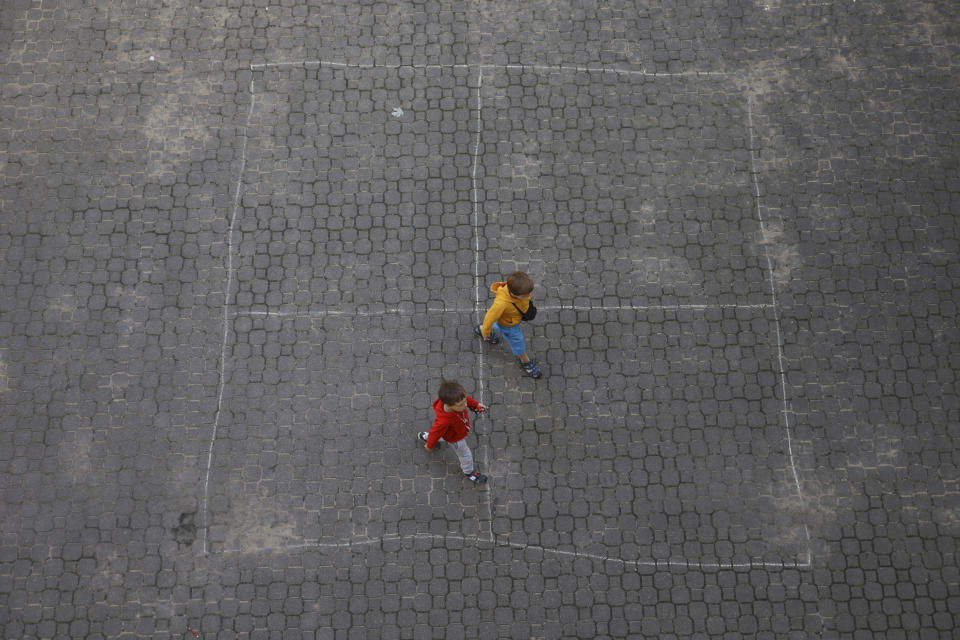 Ukrainian refugee children walk along the backyard of the Lauder Morasha Jewish school in Warsaw, Poland, Thursday, July 28, 2022. A special summer camp run by Jewish organizations has brought Jewish volunteers from the former Soviet Union to Warsaw to help Ukrainian children. The camp, which ran for most of July and ended Friday, was organized to bring some joy to traumatized children, help prepare them for the school year ahead in Polish schools and give their mothers some time to themselves. (AP Photo/Michal Dyjuk)