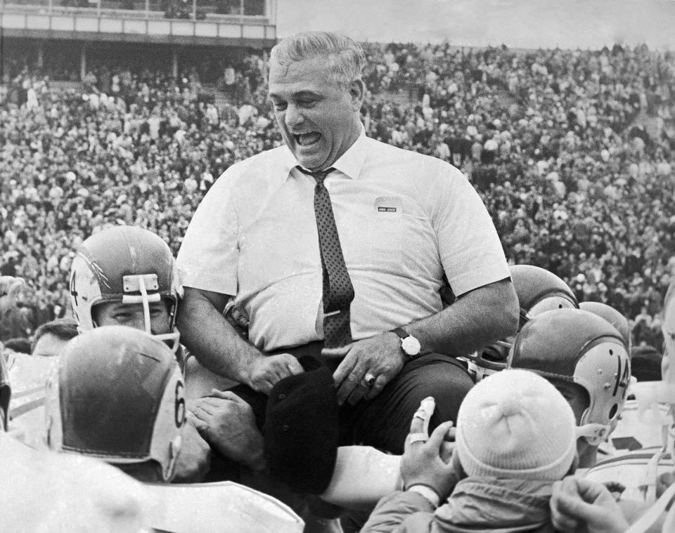 FILE - In this Nov. 20, 1965, file photo, Ohio State coach Woody Hayes is carried by his players after Ohio State defeated Michigan 9-7 in Ann Arbor, Mich. Hayes was fired after punching Clemson’s Charlie Bauman on Dec. 29, 1978, at the Gator Bowl in Jacksonville, Fla. (AP Photo/Paul Shane, File)