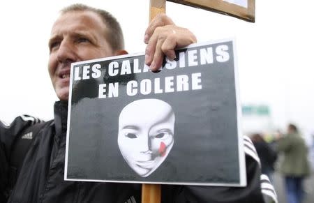 Harbor workers, truck drivers, farmers, storekeepers and residents attend a protest demonstration on the motorway against the migrant situation in Calais, France, September 5, 2016. REUTERS/Charles Platiau