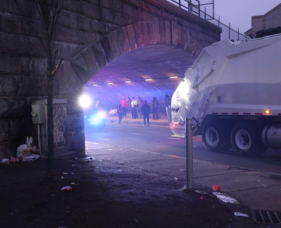 Brockton city workers clean under the School Street bridge where people who are homeless are staying on Tuesday, Dec. 26, 2023.