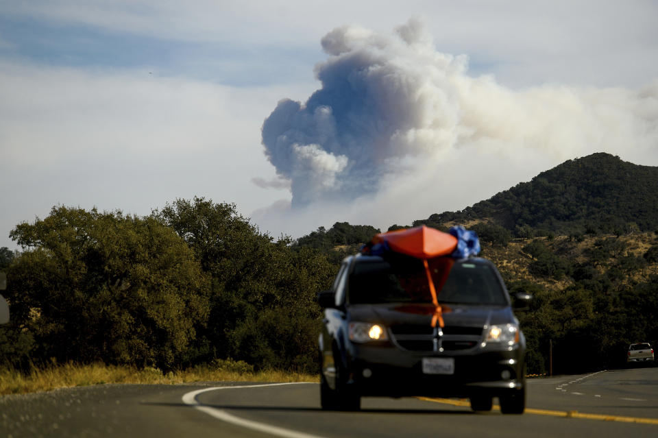 Seen from Santa Ynez, Calif., smoke from the Cave Fire plumes over Los Padres National Forest on Tuesday, Nov. 26, 2019. (AP Photo/Noah Berger)