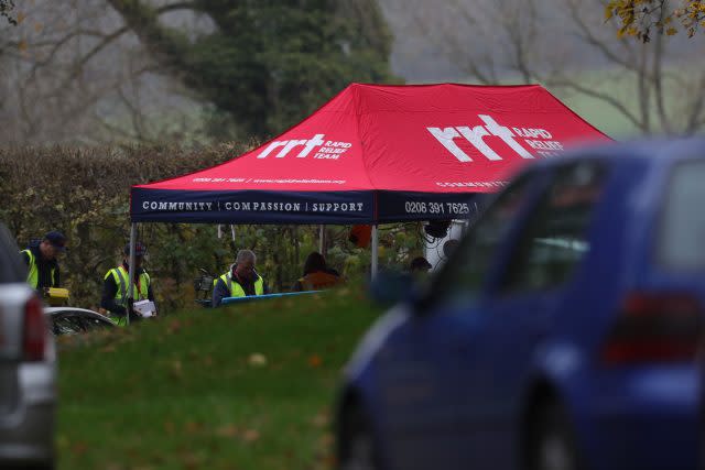 A rapid relief tent is put up at the entrance to the crash site