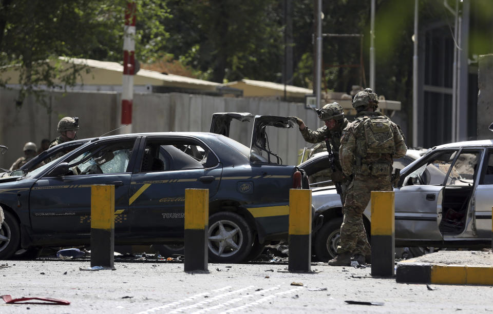 Resolute Support (RS) forces inspect the site of a car bomb explosion in Kabul, Afghanistan, Thursday, Sept. 5, 2019. A car bomb rocked the Afghan capital on Thursday and smoke rose from a part of eastern Kabul near a neighborhood housing the U.S. Embassy, the NATO Resolute Support mission and other diplomatic missions. (AP Photo/Rahmat Gul)