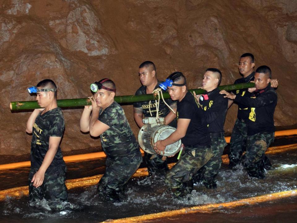 Thai authorities are pumping water from the caves (EPA)