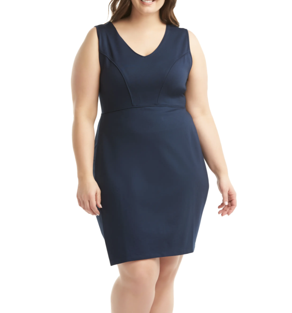 plus size model posing in navy sleeveless sheath dress 