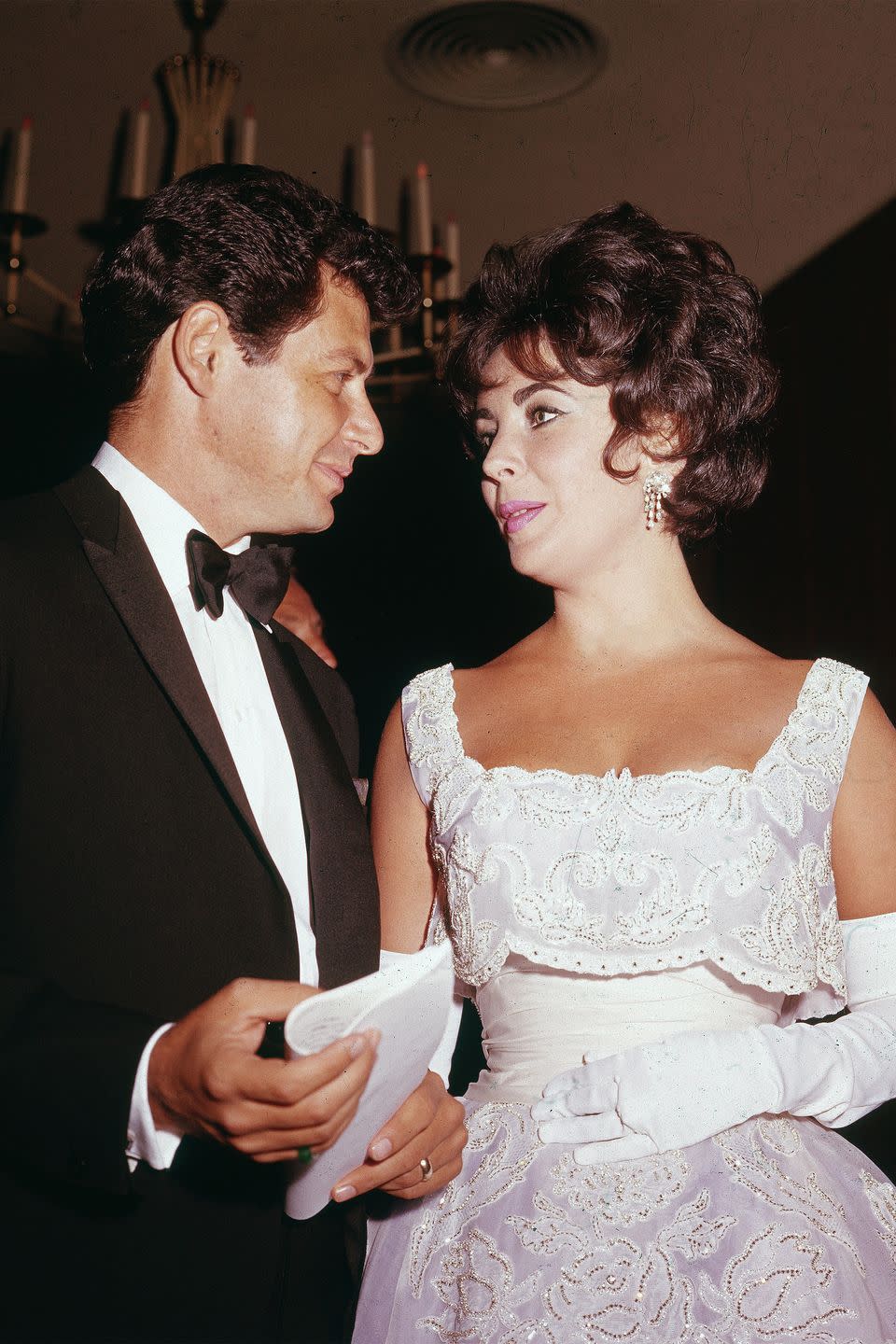 <p>While Elizabeth Taylor did coin the phrase, "diamonds are a girl's best friend," she kept her accessories to the minimal and really let her white lace dress do all the talking. </p>