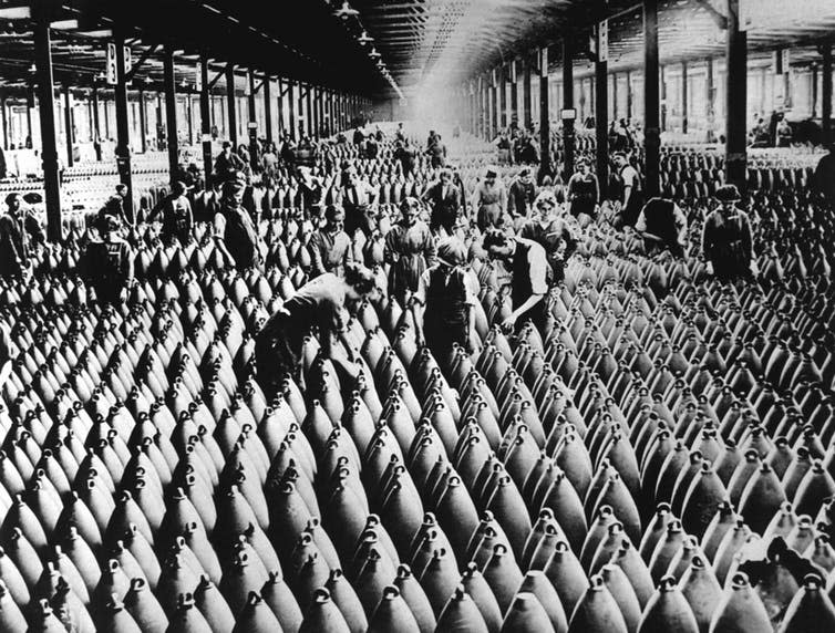 <span class="caption">A munitions factory during the war. Universities played their part in developing weaponry.</span> <span class="attribution"><a class="link " href="https://www.shutterstock.com/image-illustration/english-women-men-working-storage-shed-245965765?src=hdA9yOjJKlKqx-bfoZ4Twg-1-2" rel="nofollow noopener" target="_blank" data-ylk="slk:Shutterstock;elm:context_link;itc:0;sec:content-canvas">Shutterstock</a></span>