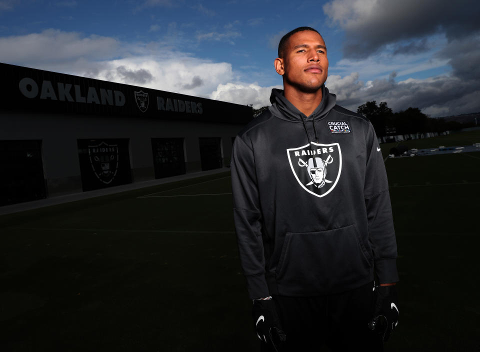 Darren Waller wears a Raiders hoodie in a close-up shot.