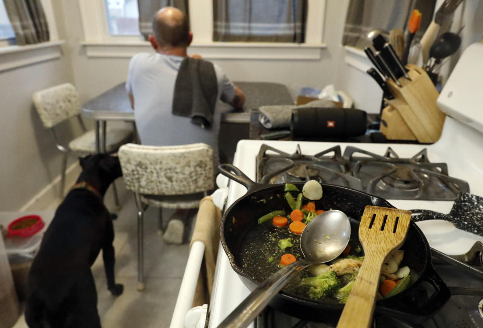 Part of Christian Hainds' carb-free meal remains on a cooking pan as he eats his dinner at his home in Hammond, Ind., Monday, June 7, 2021. Health officials have warned since early on in the pandemic that obesity and related conditions such as diabetes were risk factors for severe COVID-19. It wasn't until he was diagnosed as diabetic around the start of the pandemic that he felt the urgency to make changes. Hainds lost about 50 pounds during the pandemic, and at 180 pounds and 5 feet, 11 inches tall is no longer considered obese. (AP Photo/Shafkat Anowar)