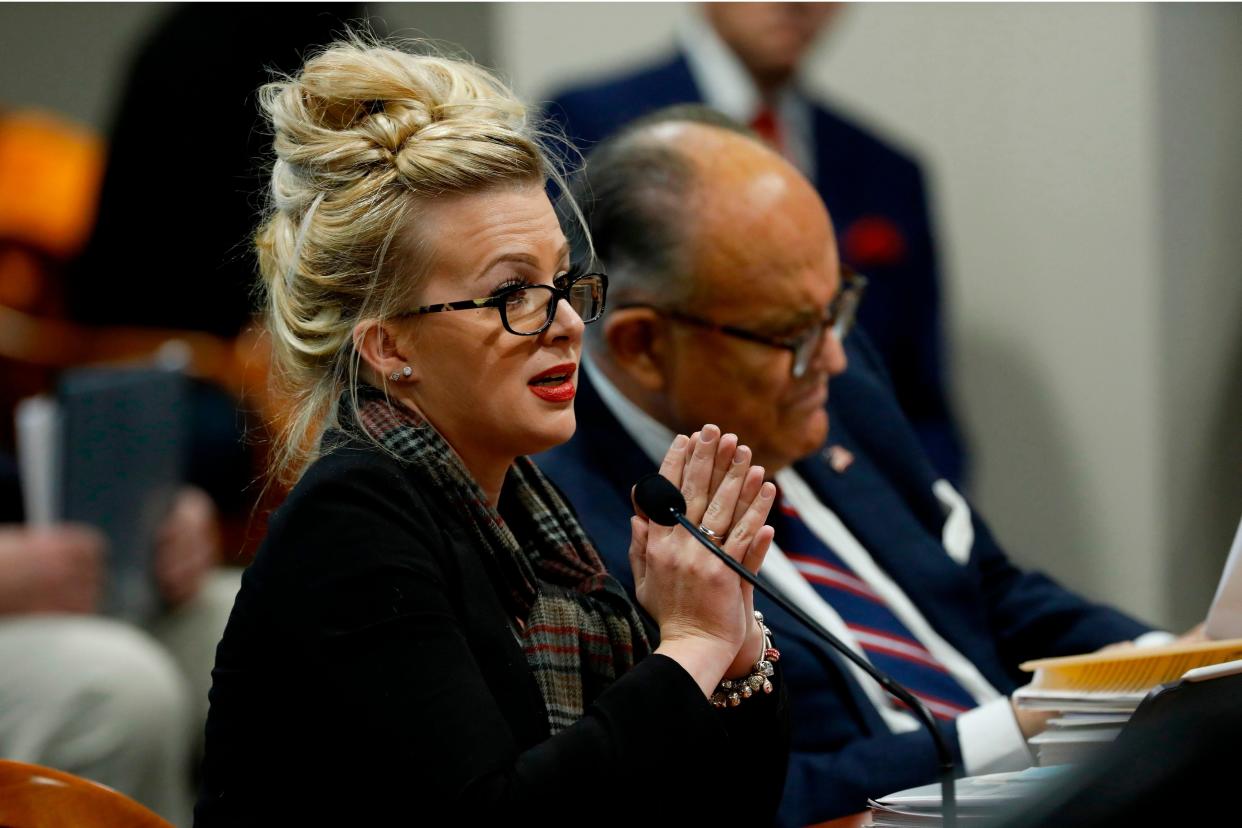 Mellissa Carone speaks on 2 December in front of the Michigan House Oversight Committee in Lansing, four days before Rudy Giuliani’s positive test was confirmed (AFP via Getty Images)